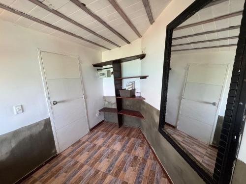 a mirror in a room with a hallway at Rosario EcoHotel in Isla Grande