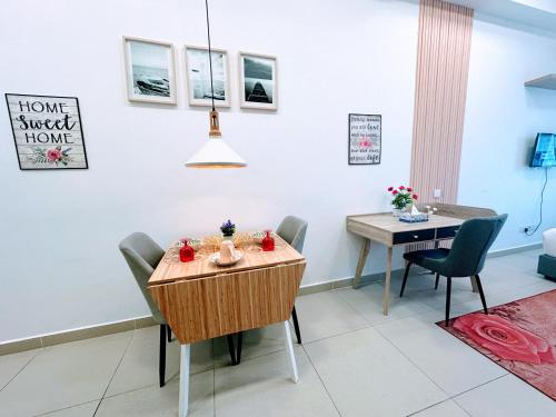 a dining room with a table and a table and chairs at THE LUXE INFINITUM RESIDENCE at KL CITY in Kuala Lumpur