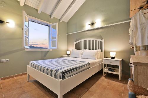 a bedroom with a large bed and a window at Asos Luxury Seafront Villas, Kefalonia, 100m beach & center, 4 stars services, Parking - near Myrtos - Fiskardo in Asos