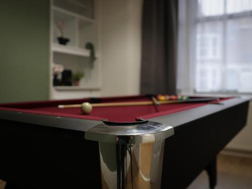 a pool table with a cue ball on top of it at London 4 Bed Contractor Base with Pool Table in Edmonton