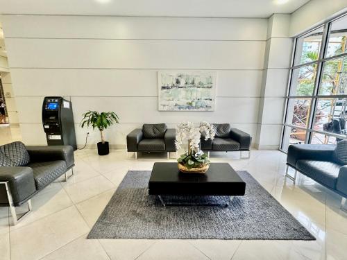 a living room with couches and a coffee table at Spacious Apt Ocean Reserve Resort Amenities in Sunny Isles Beach