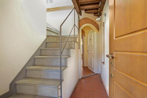 a hallway with stairs in a house with a door at La Maison in Bergamo