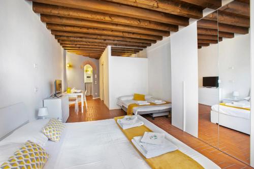 a large room with two beds and a table at La Maison in Bergamo