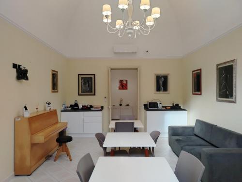a living room with a couch and a piano at Palazzo Castellano in Lecce