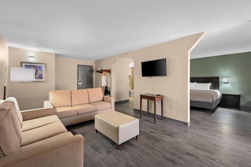 a living room with a couch and a bed at Quality Inn Fort Myers Cape Coral in Fort Myers