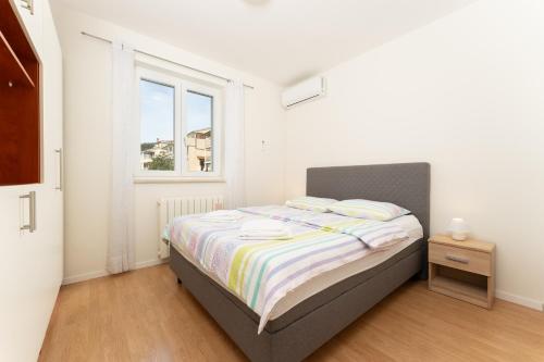 Postel nebo postele na pokoji v ubytování Apartments Oriana