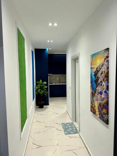 a hallway with a large painting on the wall at EKAM Sun Apartments in Golem