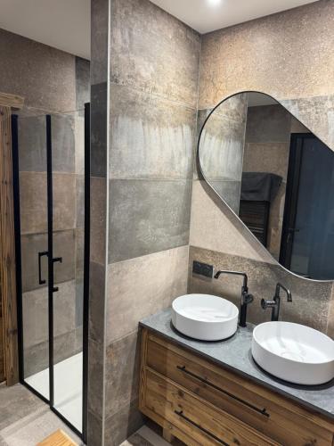 a bathroom with two sinks and a mirror at Chalet Mélèzes in Les Angles
