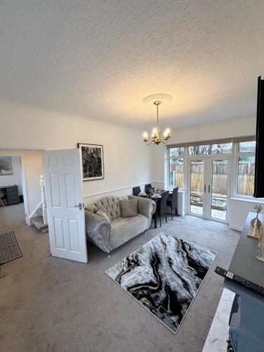 a living room with a couch and a table at Bramcote Lane Luxury Apartments in Nottingham