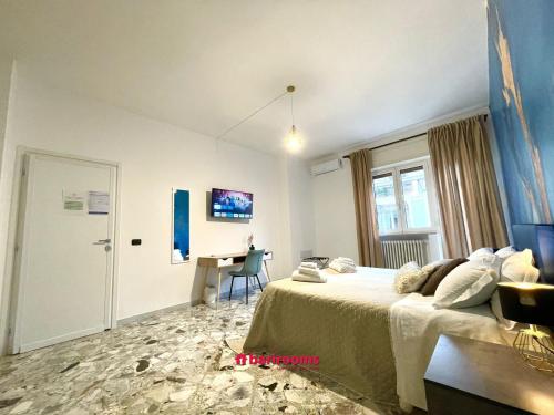 a bedroom with a bed and a desk in it at Barirooms Piccinni in Bari