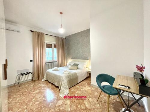a bedroom with a bed and a desk and a table at Barirooms Piccinni in Bari