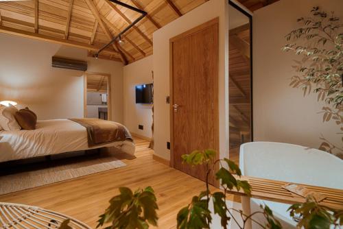 a bedroom with a bed and a sliding glass door at Mater Hotel in Canela