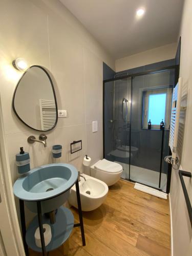 a bathroom with a sink and a toilet and a shower at Nonno Nicola Rooms in Bari