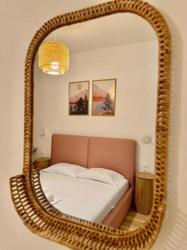 a bedroom with a bed with a large mirror at TIS, Green Coast in Palasë