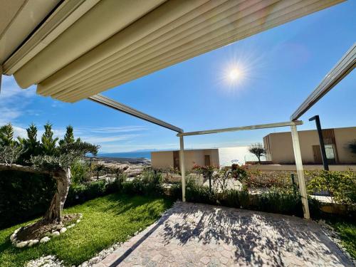 a patio with a view of the ocean from a house at TIS, Green Coast in Palasë