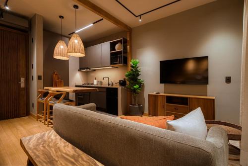 a living room with a couch and a kitchen at Mater Hotel in Canela