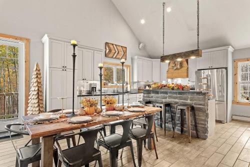 a kitchen with a large wooden table and chairs at Belleayre Mountain House in Arkville