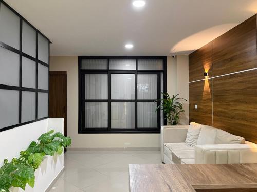 a living room with a couch and a window at Hotel Encanto in Popayan