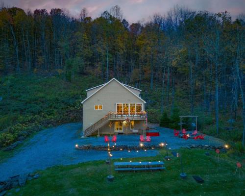 a barn with lights in front of a house at Belleayre Mountain House in Arkville