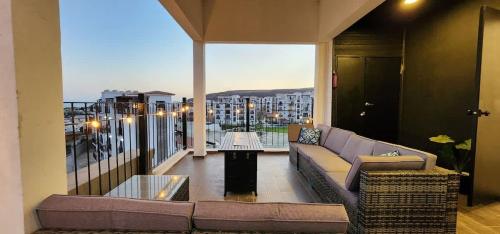 a living room with a couch and a balcony at Ensenada Valle PH in Ensenada