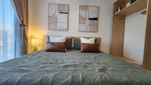 a bedroom with a large bed with two pillows at Ensenada Valle PH in Ensenada