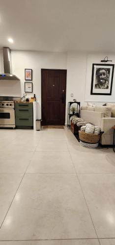 a large living room with a kitchen and a stove at Ensenada Valle PH in Ensenada
