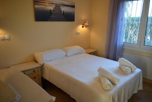a bedroom with two beds with towels on them at Anacasa Picasso Oliva Nova CH1400 in Oliva