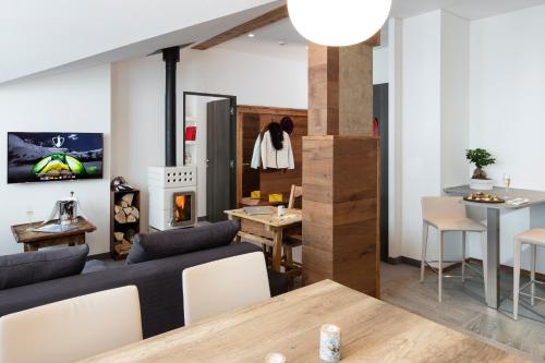 a living room with a couch and a table at Hotel Pashmina Le Refuge in Val Thorens