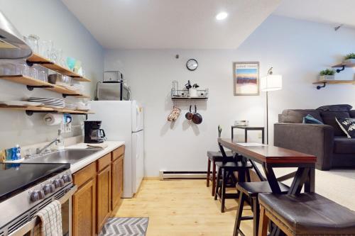 a kitchen with a sink and a table in a room at SlopeSide Escape in Newry
