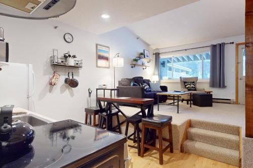 a kitchen and living room with a table and chairs at SlopeSide Escape in Newry