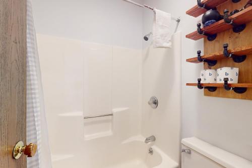 a bathroom with a white tub and a shower at SlopeSide Escape in Newry