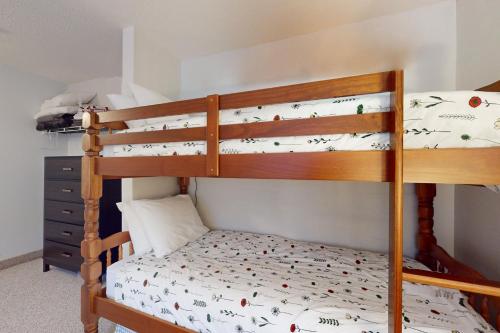 two bunk beds in a room with a bed at SlopeSide Escape in Newry