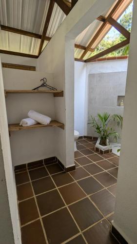 a room with a tiled floor and a ceiling at Pacific Waves Hostel & Surf in El Valle