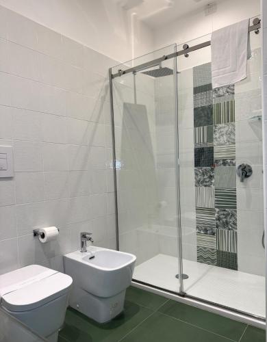 a bathroom with a shower and a toilet and a sink at Pharus Miseni Suites and rooms in Bacoli