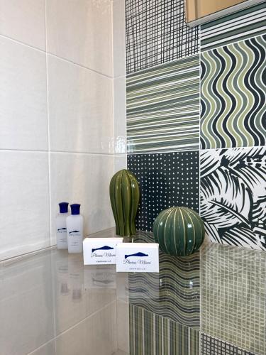 a room with two cactuses on a counter with tiles at Pharus Miseni Suites and rooms in Bacoli