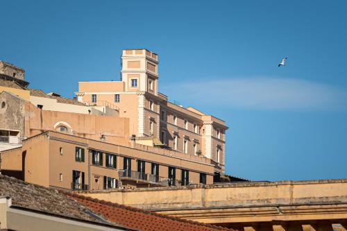a building with a clock tower on top of it at Marcus Suite in Cagliari