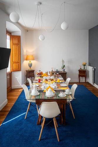 a dining room with a table with food on it at Marcus Suite in Cagliari