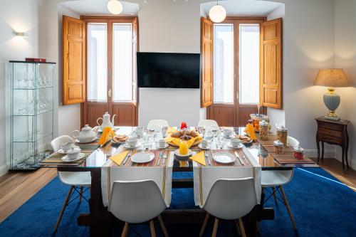 a dining room with a large table and chairs at Marcus Suite in Cagliari
