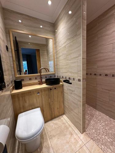 a bathroom with a toilet and a sink and a mirror at Beach house 'Tiempo Lento' in Torrox Costa
