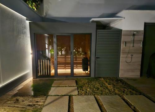 an open door of a house with a person walking outside at TG NEW Luxury Private Resort & SPA Villas - Heated Salty Swimming Pool, Outdoor Jacuzzi, Sauna, Exotic Garden in Limassol
