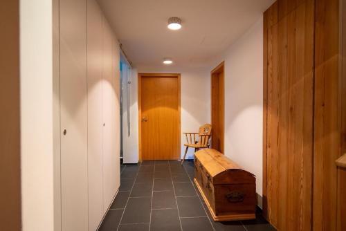 a hallway with a wooden bench and a door at Chalet a Saint Moritz with Sauna Privata in Pontresina