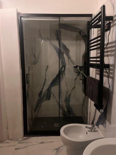 a bathroom with a shower with a toilet and a sink at Infinity Passion in Rho