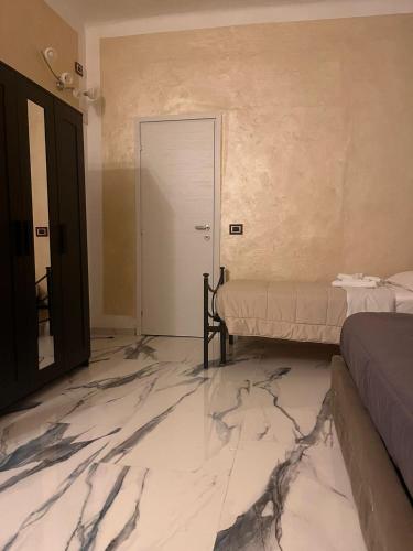a room with a marble floor and two beds at Infinity Passion in Rho