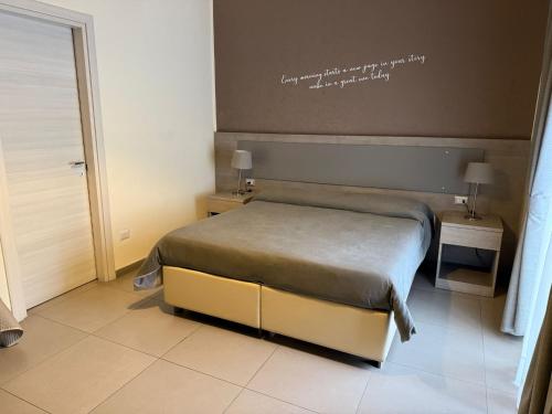 a bedroom with a bed and two tables with lamps at Bed and Breakfast Aereoparking in Naples