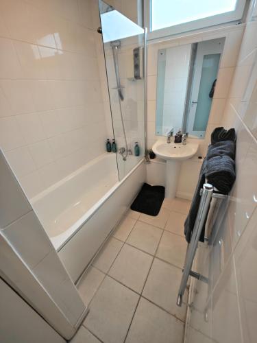 a bathroom with a shower tub and a sink at 2 Bedroom Flat Next to Lord's Cricket Ground, Central London in London
