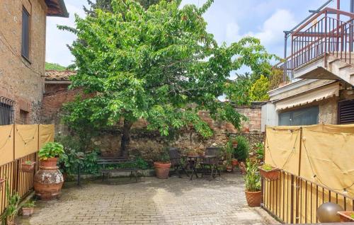 a patio with a tree and a table and a bench at Pescini's Home in Rosia