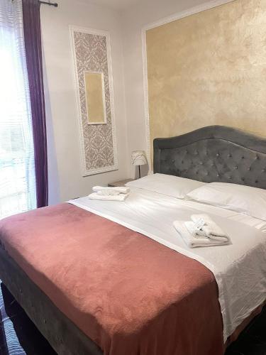 a bedroom with a bed with two towels on it at Infinity Passion in Rho