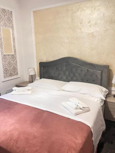 a bedroom with a large bed with two towels on it at Infinity Passion in Rho
