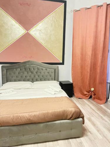 a bedroom with a bed and a painting on the wall at Infinity Passion in Rho