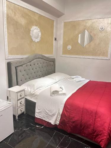 a bedroom with a bed with a red blanket at Infinity Passion in Rho
